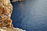 Rocky Coastline Overlooking A Blue Calm Sea Stock Photo