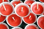 Row Of Red Candles In Small Trays Stock Photo