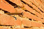 Rusty Nail On Brick Wall Stock Photo