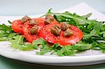Salad With Fresh Tomatoes, Capers And Arugula Stock Photo