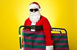 Santa Claus Going To Relax Holding Chair Stock Photo