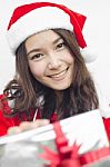 Santa Claus Hat With Grey Christmas Gift Box Stock Photo