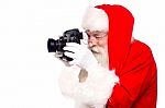 Santa Claus Taking Photo By Camera Stock Photo