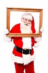 Santa Posing Holding Wooden Frame Stock Photo