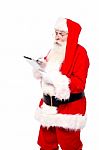 Santa Selecting Options While Surfing Stock Photo