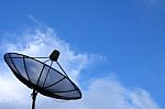 Satellite Dish Against Blue Sky Stock Photo