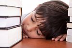 School Boy Tired Of Studying And Sleeping With Books Stock Photo