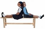 School Girls Leaning Against Each Other Stock Photo