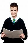 Schoolboy Holding Notebook Stock Photo