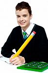Schoolboy Writing on notebook Stock Photo