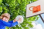 Schoolchild Aiming Ball At Board With Basket Stock Photo