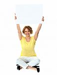 Seated Lady Showing Blank Billboard Stock Photo