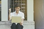 Senior Asian Woman Celebrate With Laptop Stock Photo