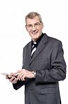Senior Businessman Using A Cell Phone Stock Photo