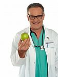 Senior Doctor holding Green Apple Stock Photo