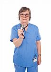 Senior Doctor Holding Stethoscope Stock Photo
