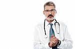 Senior Male Doctor Keeping Hands Clasped Stock Photo