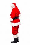 Senior Man In Santa Costume Turned Around Stock Photo