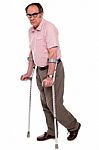 Senior Man walking With Crutches Stock Photo