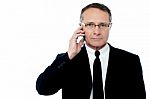 Serious Businessman Talking On The Phone Stock Photo