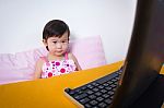 Serious Child Sitting And Looking A Story On Digital Tablet Comp Stock Photo