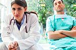 Serious Female Doctor With Colleague In Hospital Stock Photo