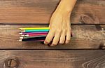 Set Of Colored Pencils In Female Hands On A Background Of Dark W Stock Photo