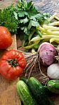 Several Vegetables On Wooden Chopping Board And Table Stock Photo