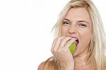 Sexy Blonde Female Eating Fresh Green Apple Stock Photo