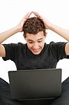 Shocked Young Man With Laptop Stock Photo