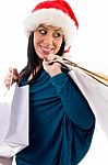 Side Pose Of Christmas Woman Holding Bags On White Background Stock Photo