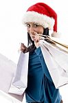 Side Pose Of Happy Christmas Model Carrying Shopping Bags Stock Photo