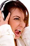 Side Pose Of Screaming Woman Listening To Music Stock Photo