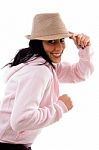 Side Pose Of Smiling Model Holding Hat On White Background Stock Photo