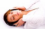 Side Pose Of Woman Lying Down On Floor Tuned To Music Stock Photo