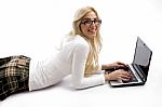 Side View Of Female Lying Down On Floor And Working On Laptop Stock Photo