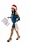 Side View Of Smiling Christmas Female Holding Carry Bags Stock Photo