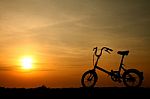 Silhouette Bicycle At Sunset Stock Photo