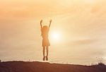 Silhouette Of Woman Jumping Against Beautiful Sky Background Stock Photo