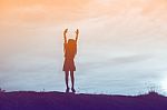 Silhouette Of Woman Praying Over Beautiful Sky Background Stock Photo