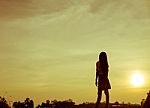 Silhouette Of Woman Praying Over Beautiful Sky Background Stock Photo