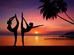 Silhouette Of Yoga Girls In Sunset Stock Photo