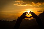 Silhouettes Hand Heart Shaped With Sun Sets Stock Photo
