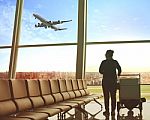 Single Woman Sitting In Airport Terminal And Passenger Plane Flying Outdoor For Traveling Theme Stock Photo