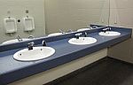 Sinks And Urinals In Mirror Stock Photo