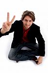 Sitting Man Showing Peace Sign Stock Photo