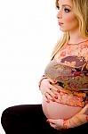 Sitting Pregnant Lady Holding Tummy Stock Photo