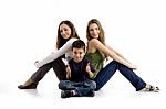 Sitting Siblings And Boy With Thumbs Up Stock Photo