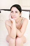 Sitting Woman Cupping Her Face Stock Photo