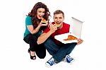 Sitting Young Couple Eating Pizza Stock Photo
